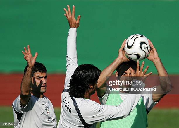 Friedrichshafen, GERMANY: Iranian defenders Rahman Rezaei , Amir Hossein Sadeqi and Yahya Golmohammadi play handball during a training session in...