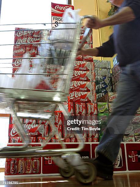 Shopper passes cartons of Coca-Cola in a grocery June 13, 2006 in Des Plaines, Illinois. Doctors at the annual American Medical Association meeting...