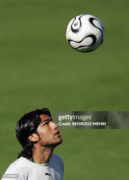 Friedrichshafen, GERMANY: Iranian defender Amir Hossein Sadeqi plays with the ball during a training session in Friedrichshafen, 13 June 2006. Iran's...