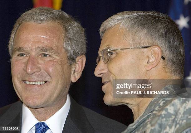 General George Casey , commander of coalition forces in Iraq, shares a few words with US President George W. Bush shortly before Bush's remarks to US...