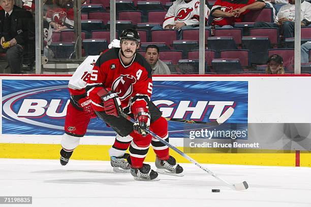 Defenseman Colin White of the New Jersey Devils controls the puck against the Carolina Hurricanes in game four of the Eastern Conference Semifinals...