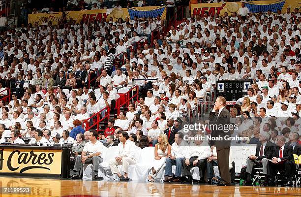 Head coach Pat Riley of the Miami Heat stands in front of silent Miami Heat fans in the crowd against the Dallas Mavericks during Game Three of the...