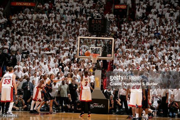 Dwyane Wade of the Miami Heat shoots and makes a free throw with 1.4 seconds left to put the Heat up 98-96 against the Dallas Mavericks during Game...