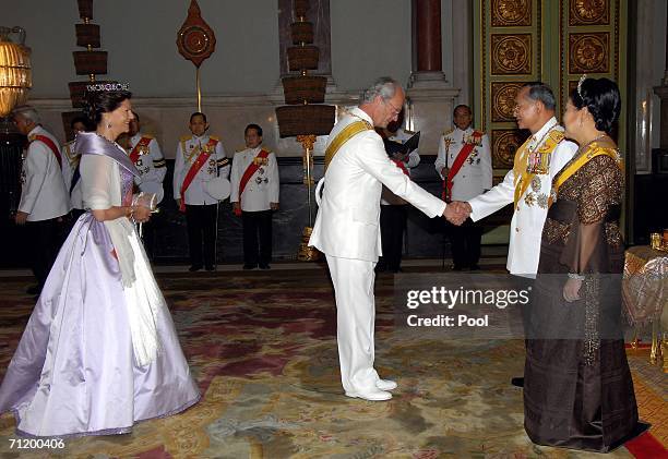 Thailand's King Bhumibol Adulyadej and Queen Sirikit greet Queen Silvia of Sweden and King Carl Gustav of Sweden as they attend the Royal banquet at...