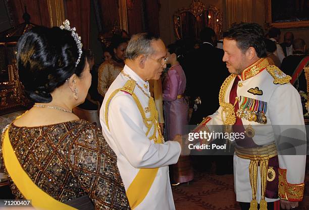 Thailand's King Bhumibol Adulyadej and Queen Sirikit greet King Abdullah II Bin Al-Hussein of Jordan as they attend the Royal banquet at the Golden...