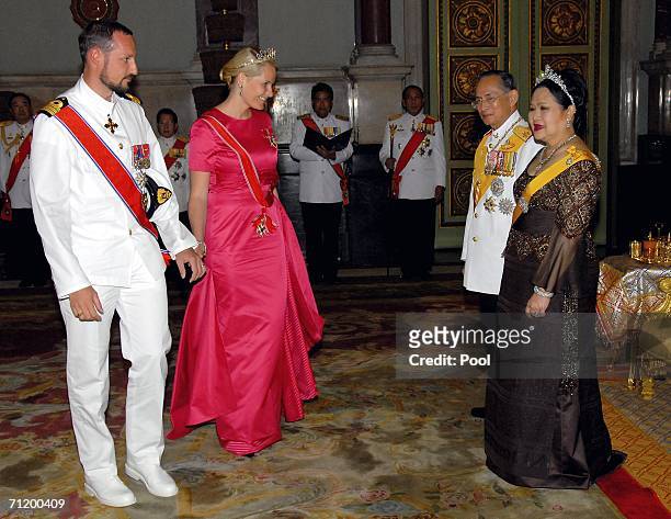 Thailand's King Bhumibol Adulyadej and Queen Sirikit greet Crown Prince Haakon of Norway and Princess Mette-Marit of Norway as they attend the Royal...