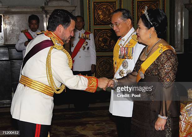 Thailand's King Bhumibol Adulyadej and Queen Sirikit greet King Abdullah II Bin Al-Hussein of Jordan as they attend the Royal banquet at the Golden...