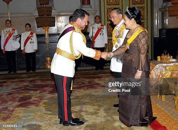 Thailand's King Bhumibol Adulyadej and Queen Sirikit greet King Abdullah II Bin Al-Hussein of Jordan as they attend the Royal banquet at the Golden...