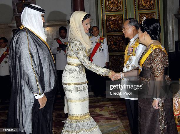 Thailand's King Bhumibol Adulyadej and Queen Sirikit greet Sheikha Moza Bin Nasir Al-Musnad of Qatar and Sheikh Hamad Bin Khalifa Al-Thani of Qatar...