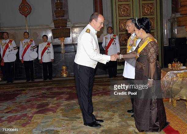 Thailand's King Bhumibol Adulyadej and Queen Sirikit greet Prince Albert II of Monaco as they attend the Royal banquet at the Golden Palace on June...