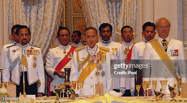 Thailand's King Bhumibol Adulyadej King Carl Gustav of Sweden and Sultan of Brunei stand during the Royal banquet at the Golden Palace on June 13,...