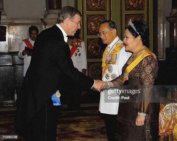 Thailand's King Bhumibol Adulyadej and Queen Sirikit greet Prince Andrew, Duke of York as they attend the Royal banquet at the Golden Palace on June...