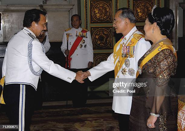 Thailand's King Bhumibol Adulyadej and Queen Sirikit greet the Sultan of Brunei as they attend the Royal banquet at the Golden Palace on June 13,...