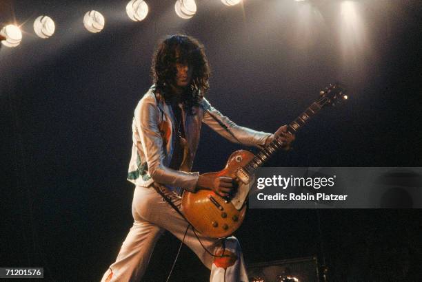 British guitarist Jimmy Page performs on stage with rock and roll group Led Zeppelin during an unidentified tour, late 1970s.