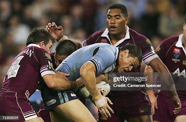 Timana Tahu of the Blues is tackled during game two of the ARL State Of Origin series between the Queensland Maroons and the New South Wales Blues at...