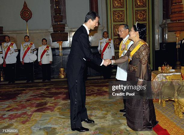 Thailand's King Bhumibol Adulyadej and Queen Sirikit greet Prince Alois of Leichtenstein as they attend the Royal banquet at the Golden Palace on...