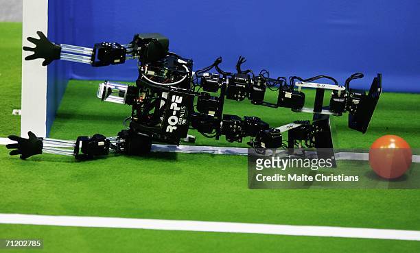 Humanoid robot of the children size league attempts a save during the Robocup 2006 football world championships at the Congress Centre on June 14,...