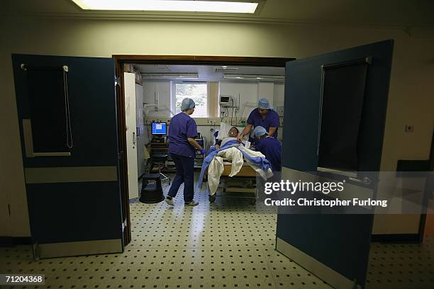 Carol Playfair is moved into the recovery room after a kidney transplant conducted by Consultant Surgeon Andrew Ready and his team t at The Queen...