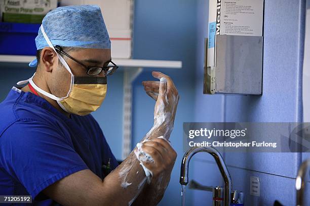 Theatre staff at The Queen Elizabeth Hospital Birmingham 'scrub up' before an operation on 14 June Birmingham, England. Senior managers of the NHS...