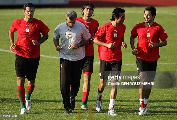 Friedrichshafen, GERMANY: : Iranian players, forward Ali Daei, trainer Hossein Faraki, defender Amir Hossein Sadeqi, forward Reza Enayati and...