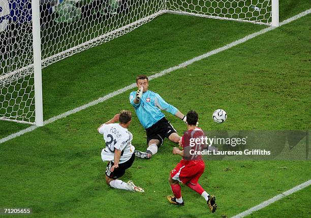 Lukas Podolski of Germany goes close to scoring as goalkeeper Artur Boruc of Poland tries to save during the FIFA World Cup Germany 2006 Group A...