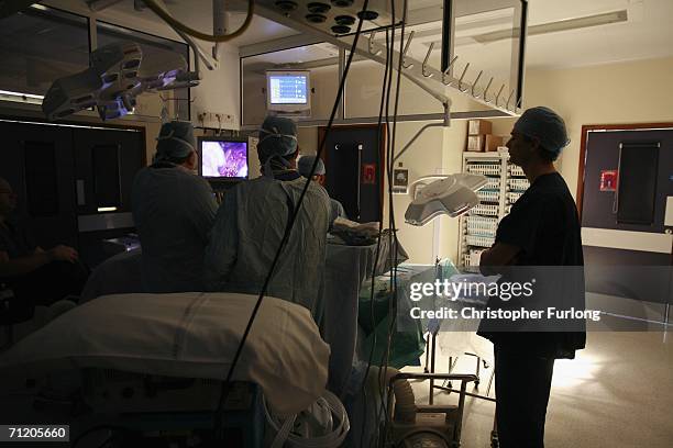 Surgeons at The Queen Elizabeth Hospital Birmingham conduct an operation June 14, 2006 in Birmingham, England. Senior managers of the NHS have said...