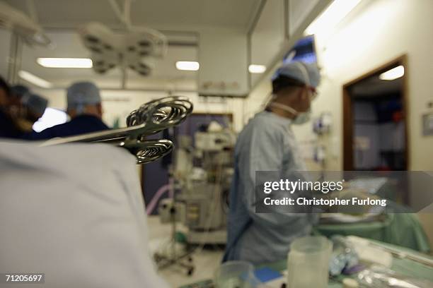 Surgeons at The Queen Elizabeth Hospital Birmingham conduct an operation on June 14, 2006 in Birmingham, England. Senior managers of the NHS have...