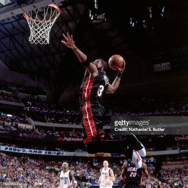 Dwyane Wade of the Miami Heat elevates for a dunk against the Dallas Mavericks during game two of the 2006 NBA Finals played June 11, 2006 at the...
