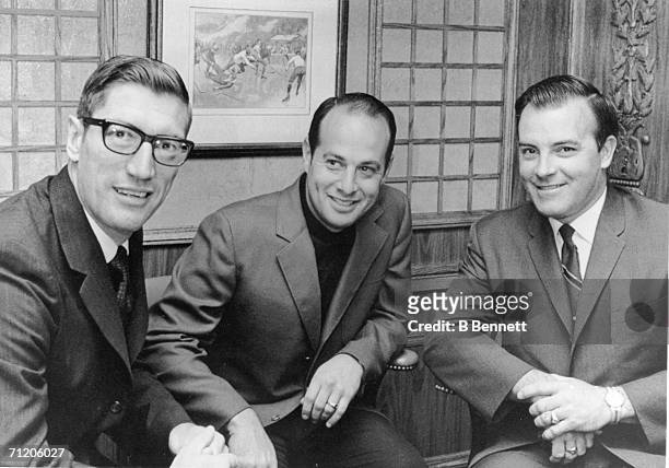 Canadian professional hockey player and coach Al Arbour sits with St. Louis Blues vice president Sid Salomon III and team general manager Scotty...