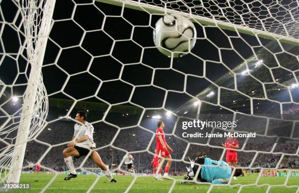 Oliver Neuville of Germany scores the winning goal as Artur Boruc of Poland fails to save during the FIFA World Cup Germany 2006 Group A match...