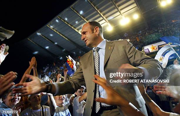 Macedonian Prime Minister and leader of Macedoni's ruling party, the Social-Democratic Union , Vlado Buckovski greets his supporters during a...