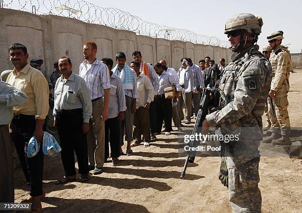 Soldiers stand guard in the prison compound, shortly before another batch of 200 prisoners are freed from Abu Ghraib prison on June 15, 2006 in...