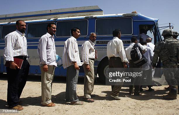 Iraqis board a bus, shortly after another batch of 200 prisoners are freed from Abu Ghraib prison on June 15, 2006 in Baghdad, Iraq. Prime Minister...