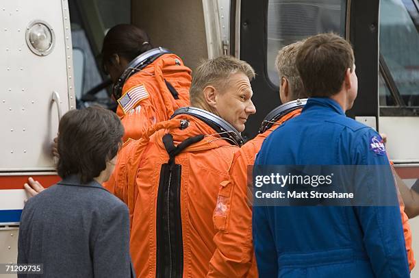 Piers Sellers, mission specialist for NASA's STS-121 shuttle mission, boards the astronaut van for transport to Space Shuttle Discovery on launch pad...