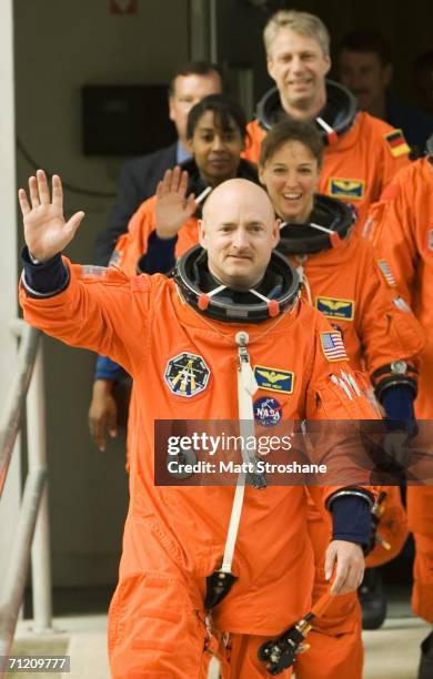 Pilot Mark Kelly leads crewmates Lisa Nowak, Stephanie Wilson and Thomas Reiter out of the Operations and Checkout building and into the astronaut...