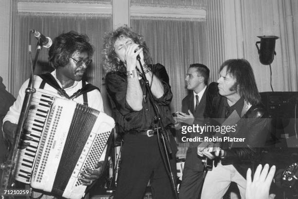 From left, American musician Buckwheat Zydeco , British musicians Robert Plant and Curt Smith , and Canadian musician Neil Young perform together at...