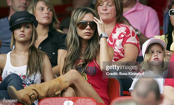 Singer Cheryl Tweedy the girlfriend of Ashley Cole, Victoria Beckham the wife of England Captain David Beckham, and their son, Romeo attend the FIFA...