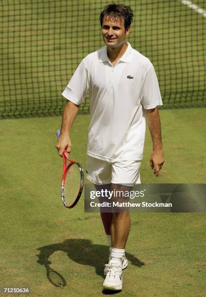 Fabrice Santoro of France walks back to the baseline after disconnecting the net sensor while playing Arnaud Clement of France June 15, 2006 during...