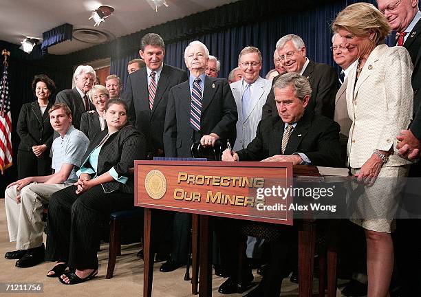 President George W. Bush signs the Miner Act into law as Randy McCloy , the sole survivor of the Sago Mine accident on January 2 his wife Anna ,...