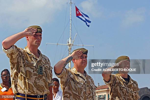 British soldiers Captain Peter Scott, Sargent Thomas Hunt and Private Darren Miles, members of the Royal Own King's Border Regiment, salute in Havana...