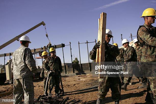 Members of the Utah Army National Guard unit 1457 work on new portions of the border fence along the Arizona-Mexico border June 15, 2006 in San Luis,...