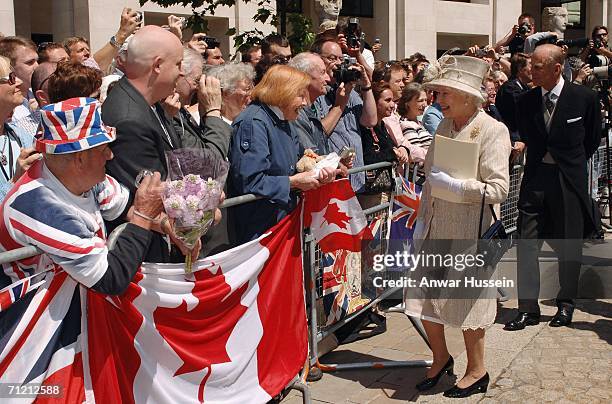 Queen Elizabeth ll, accompanied by the Prince Philip, Duke of Edinburgh, smiles at the crowd during a walkabout following a Service of Thanksgiving...