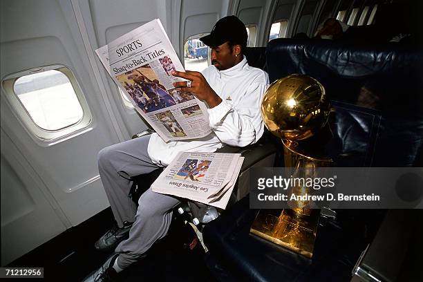 Kobe Bryant of the NBA Champion Los Angeles Lakers relaxes on board the Lakers' team flight back to Los Angeles the day after defeating the...