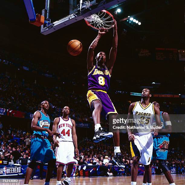 Kobe Bryant of the Los Angeles Lakers goes up for a slam dunk in the All-Star Rookie Game during the 1997 NBA All-Star Week at Gund Arena in...