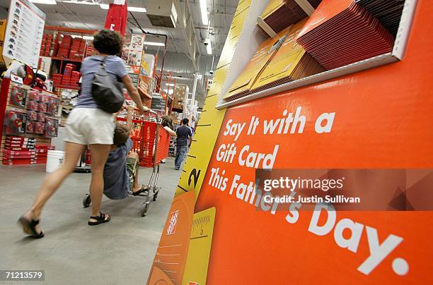 Home Depot customer walks by a display of Father's Day gift cards at a Home Depot store on June 15, 2006 in San Rafael, California. Retail outlets...