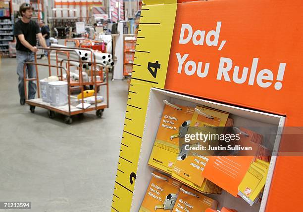 Home Depot customer walks by a display of Father's Day gift cards at a Home Depot store on June 15, 2006 in San Rafael, California. Retail outlets...