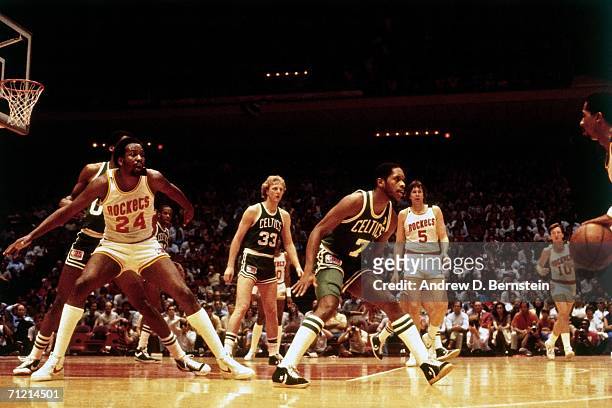 Moses Malone of the Houston Rockets posts up against Robert Parish of the Boston Celtics during a game in 1981 at the Houston Summit in Houston,...