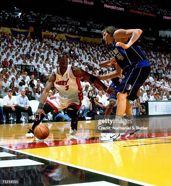 Dwyane Wade of the Miami Heat drives to the basket against Dirk Nowitzki of the Dallas Mavericks during game three of the 2006 NBA Finals played June...