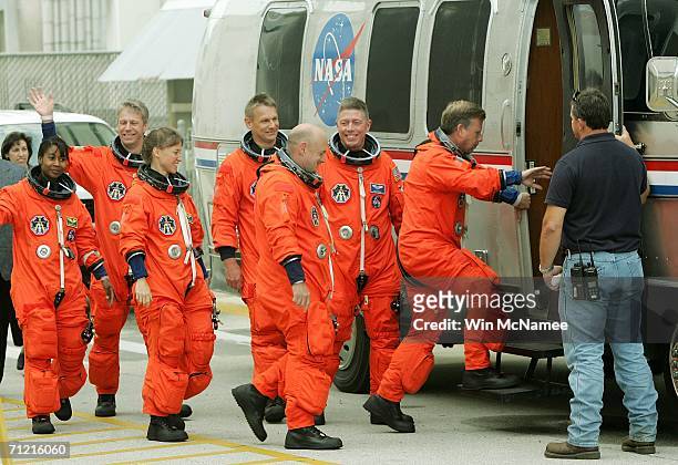 Astronauts for the next Space Shuttle mission, STS-121, make their way from the Operations and Checkout building and into the astronaut van for...