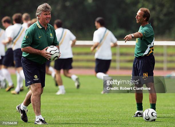 Australian coach Guus Hiddink jokes with assistant coach Johan Neeskens during the Australian training session at the Otto-Meister Stadium June 16,...
